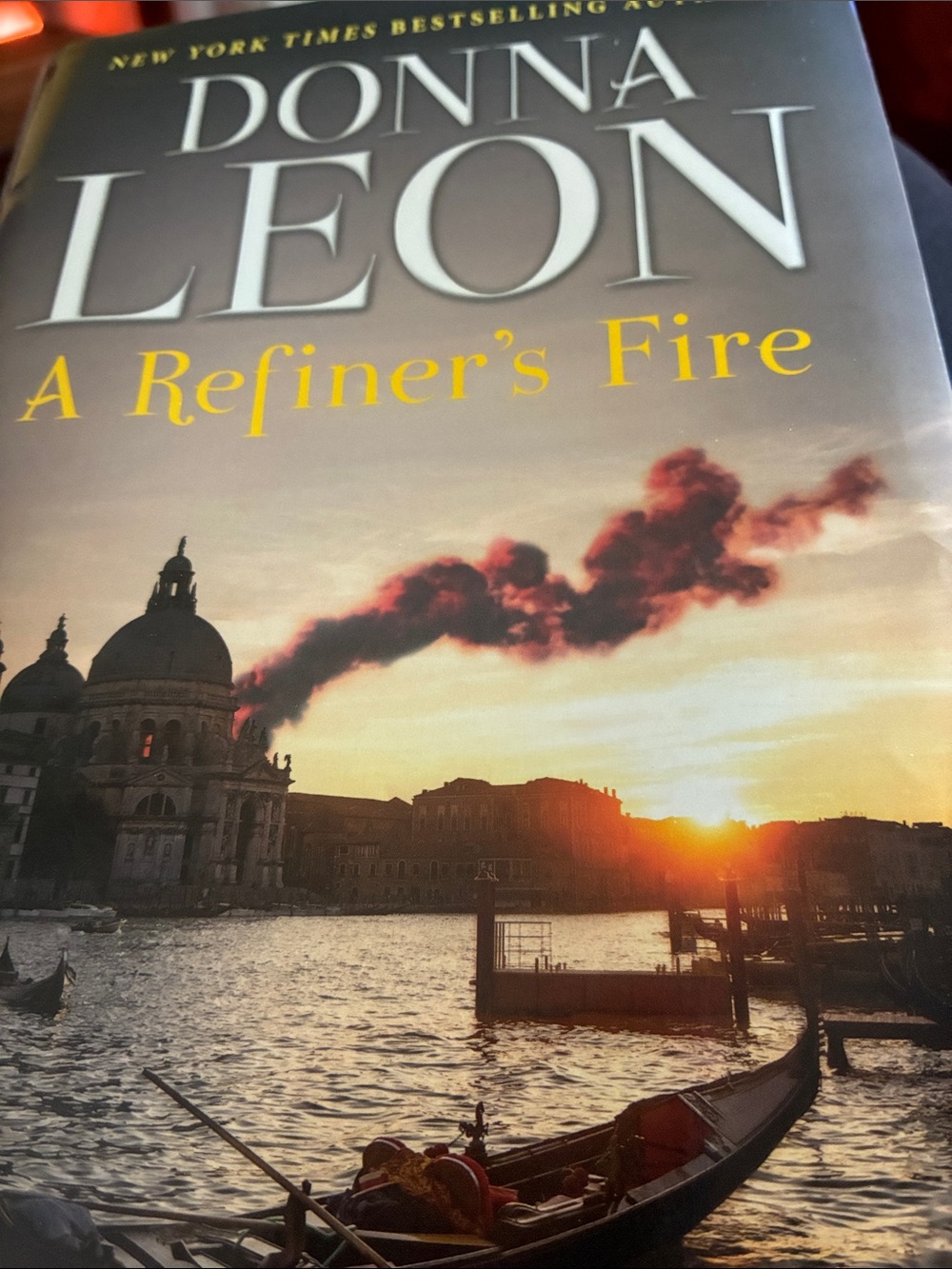 Donna Leon "A Refiner's Fire" Hardcover Book - Yellow Title, Sunset Cover